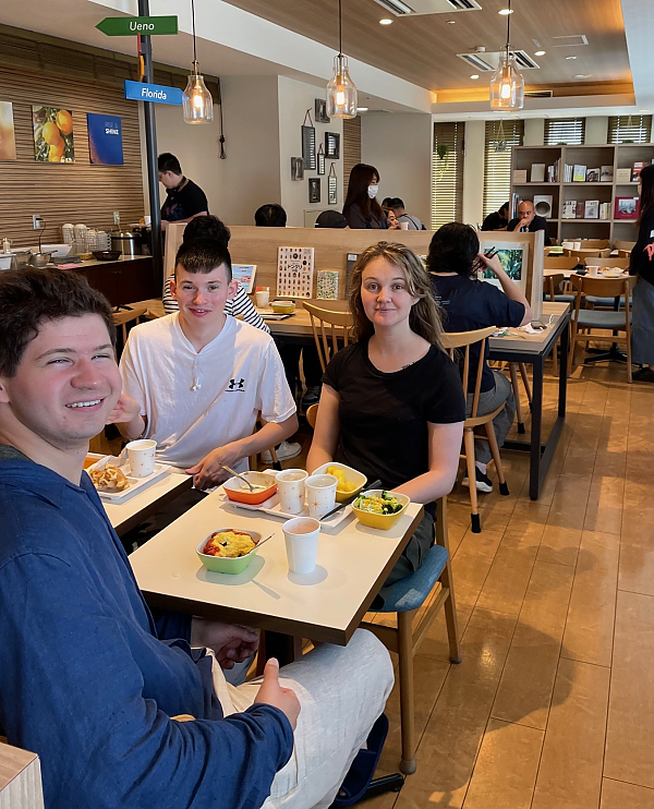 Three students sitting together at breakfast