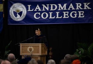 Dr. Karrie Kalich wearing black robe and mortar board while making remarks at podium during Spring 2024 Convocation