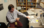 Student Michael Conn flips through binders of photographic negatives, which he is cataloging for the Landmark College archives as part of his Employment Readiness Experience during the 2018 January term. 
