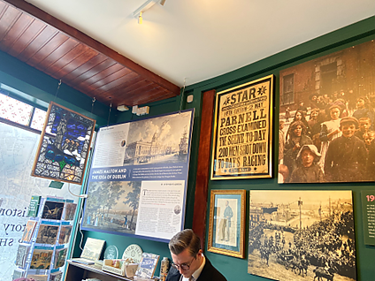 Paintings and photos on a wall inside the Little Museum of Dublin