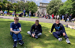 Three students sitting on St. Stephens Green on first day of the Ireland 2024 study abroad trip