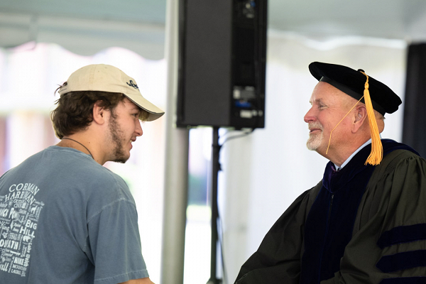 New student shaking hands with Interim President Dr. Jim Dlugos during the Fall 2024 convocation ceremony