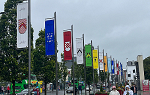 A row of colorful banners hanging from poles along a street in Galway, Ireland
