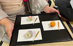 Tray with colorful tea ceremony treats on 3 different white plates
