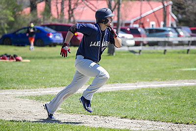Landmark College baseball player heads for first base.