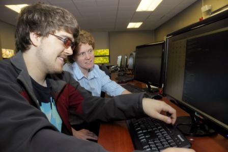 Landmark College student Kyle Vanderwiel works with faculty member Michelle Bower in a computer lab.